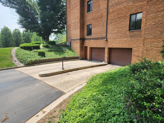 709 79th St Unit 309, Darien, IL 60561 - view of side of home with an attached garage and brick siding