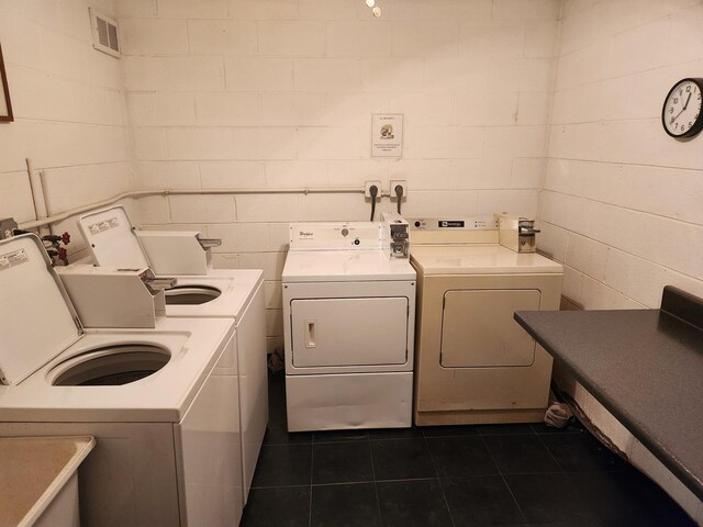 709 79th St Unit 309, Darien, IL 60561 - community laundry with washer and clothes dryer, dark tile patterned floors, and concrete block wall