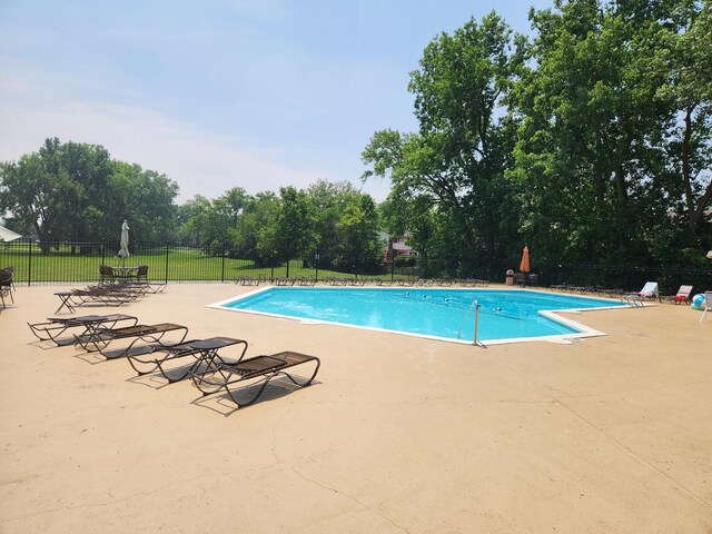 709 79th St Unit 309, Darien, IL 60561 - community pool featuring a patio area and view of wooded area