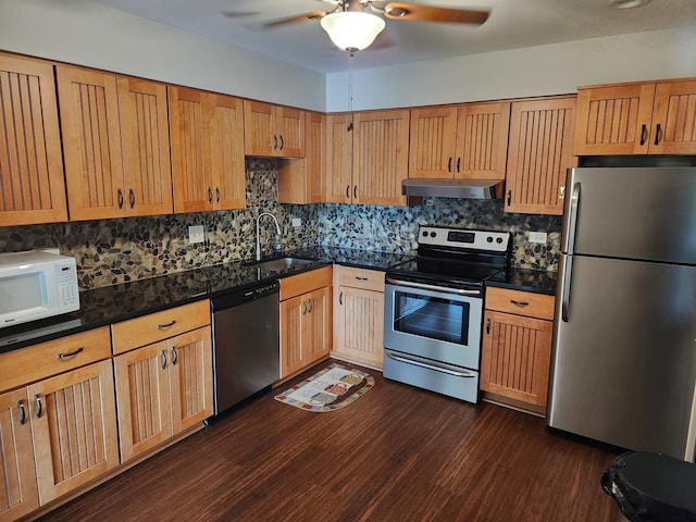 709 79th St Unit 309, Darien, IL 60561 - kitchen with stainless steel appliances, under cabinet range hood, a sink, dark wood-style flooring, and tasteful backsplash