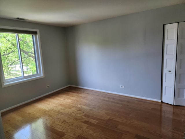 709 79th St Unit 309, Darien, IL 60561 - empty room featuring wood finished floors and baseboards
