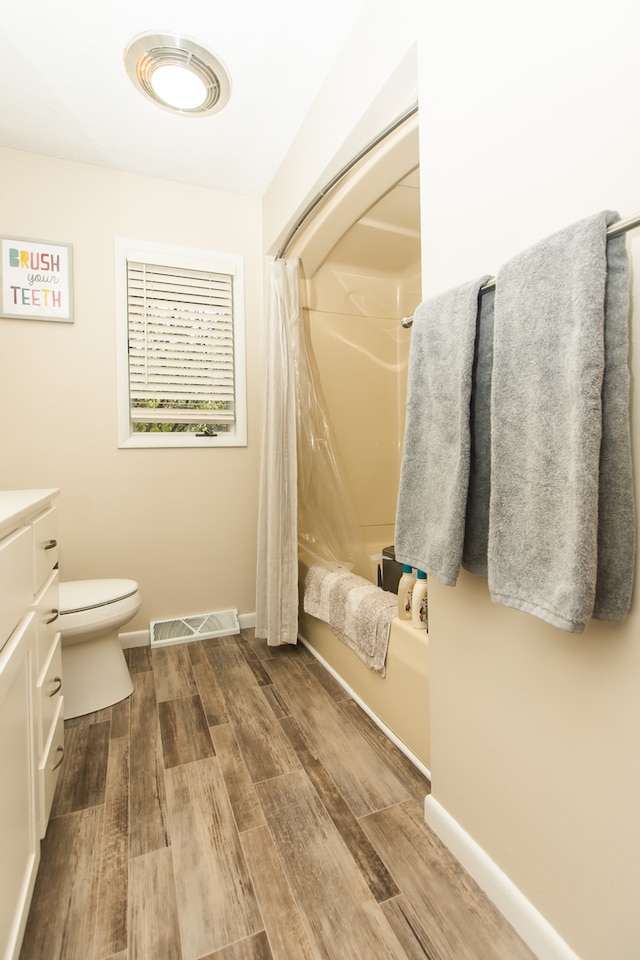 full bathroom featuring vanity, toilet, wood-type flooring, and shower / bathtub combination with curtain