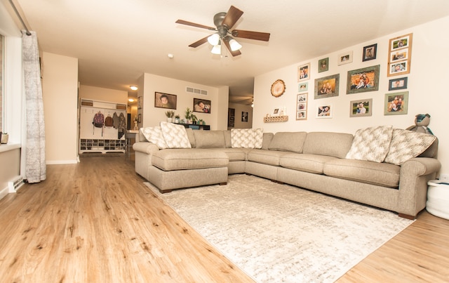 living room featuring hardwood / wood-style flooring and ceiling fan