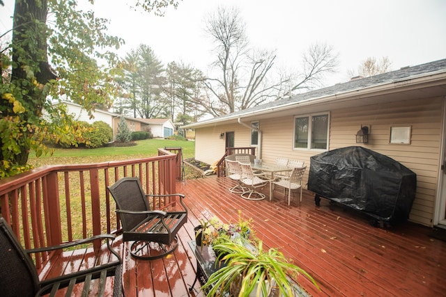 wooden terrace with a yard and a grill