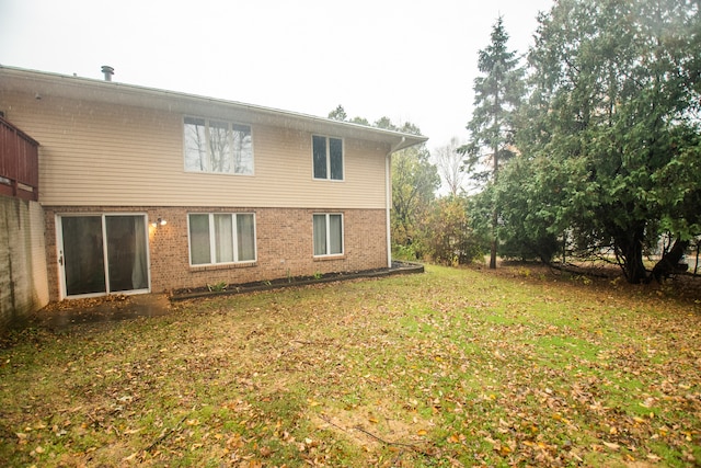 rear view of property with a lawn