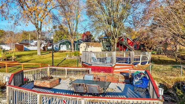 deck with a yard and a fire pit