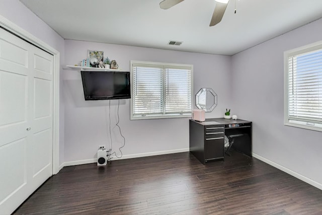 office area featuring dark wood-type flooring, ceiling fan, and a healthy amount of sunlight