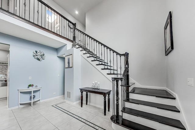 stairway featuring tile patterned flooring