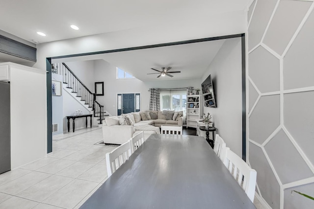 tiled living room with ceiling fan and vaulted ceiling