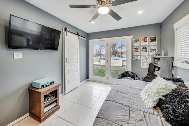 bedroom featuring ceiling fan, light tile patterned flooring, access to exterior, and a barn door