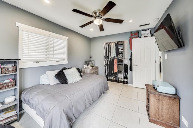 tiled bedroom featuring ceiling fan