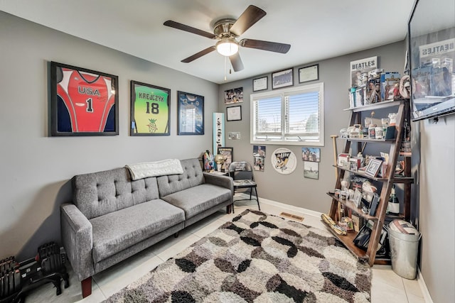 living room featuring ceiling fan and light tile patterned floors