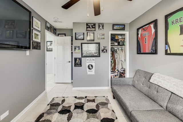 living room featuring light tile patterned floors and ceiling fan