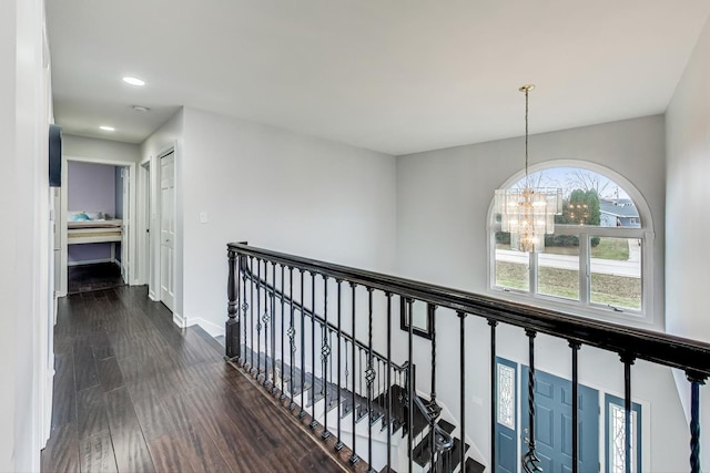 corridor featuring a chandelier and dark hardwood / wood-style floors