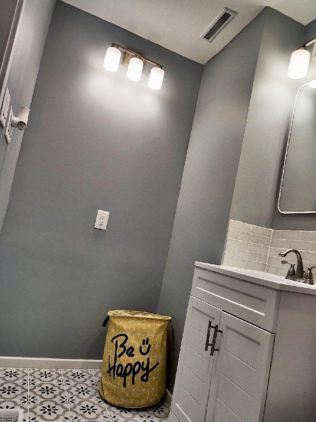 bathroom featuring decorative backsplash and vanity