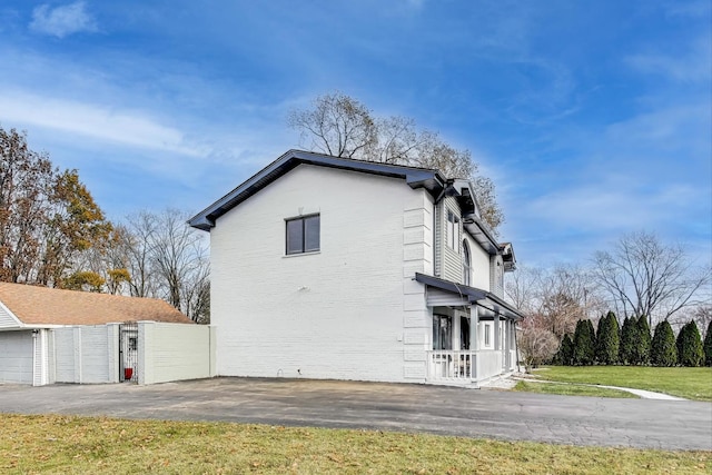 view of side of home with a yard