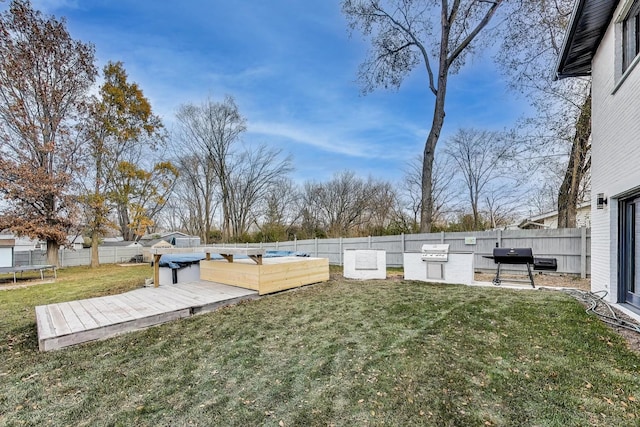 view of yard featuring a trampoline and a deck