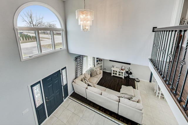 tiled living room with a notable chandelier