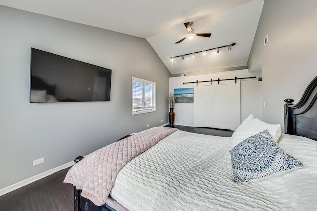 bedroom with ceiling fan, hardwood / wood-style floors, track lighting, and lofted ceiling