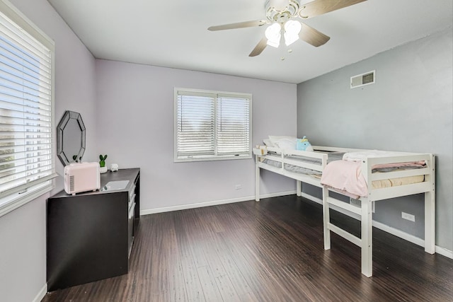 bedroom with ceiling fan and dark hardwood / wood-style floors