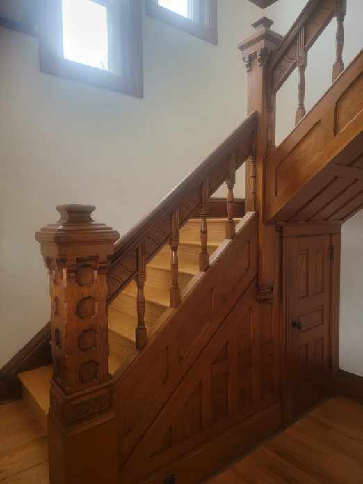 staircase with hardwood / wood-style flooring