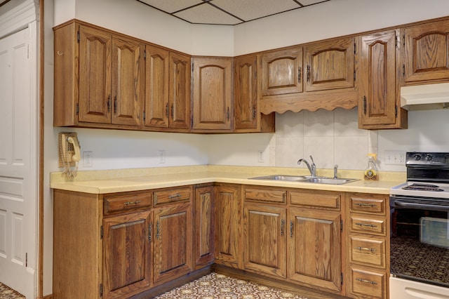 kitchen with black electric range, a paneled ceiling, and sink