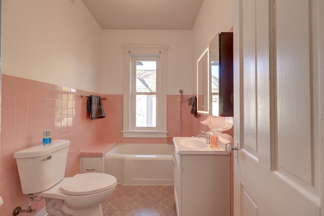 bathroom featuring tile walls, toilet, vanity, and tile patterned floors