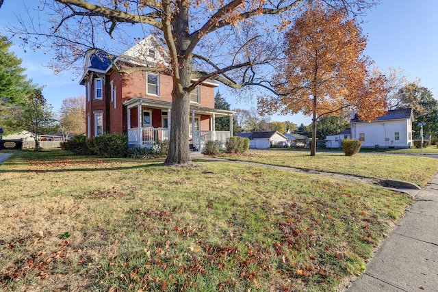 view of front of house with covered porch and a front yard