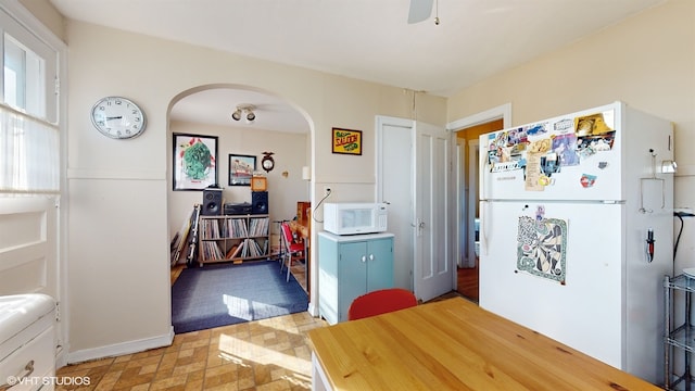 kitchen featuring white appliances and ceiling fan