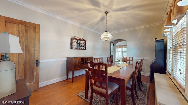 dining room featuring a chandelier, wood-type flooring, and ornamental molding