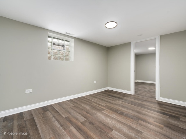 basement featuring dark hardwood / wood-style flooring