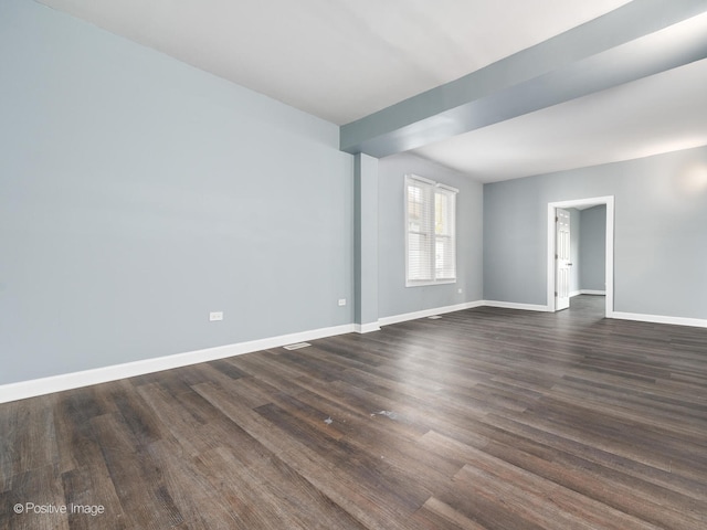 empty room with dark hardwood / wood-style flooring