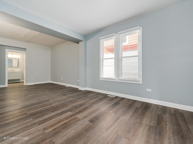 unfurnished room featuring dark hardwood / wood-style flooring