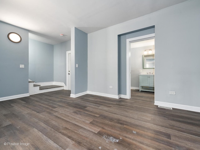 spare room with dark wood-type flooring