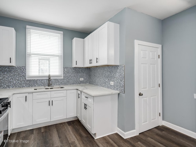 kitchen featuring sink, white cabinets, dark hardwood / wood-style floors, and tasteful backsplash