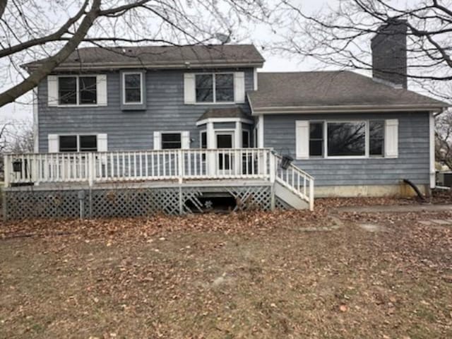 back of house featuring a deck