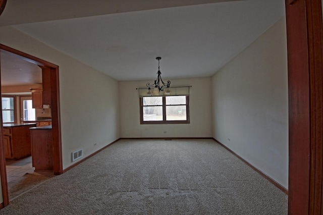 unfurnished bedroom with carpet, ceiling fan, and two closets