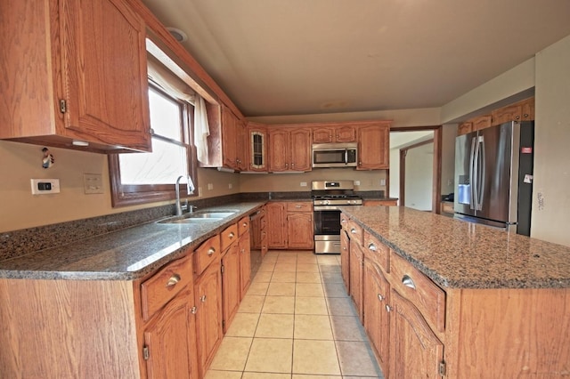 kitchen featuring light tile patterned flooring, appliances with stainless steel finishes, and sink