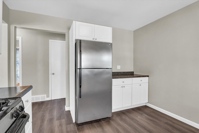 kitchen featuring white cabinetry, stainless steel appliances, and dark wood-type flooring