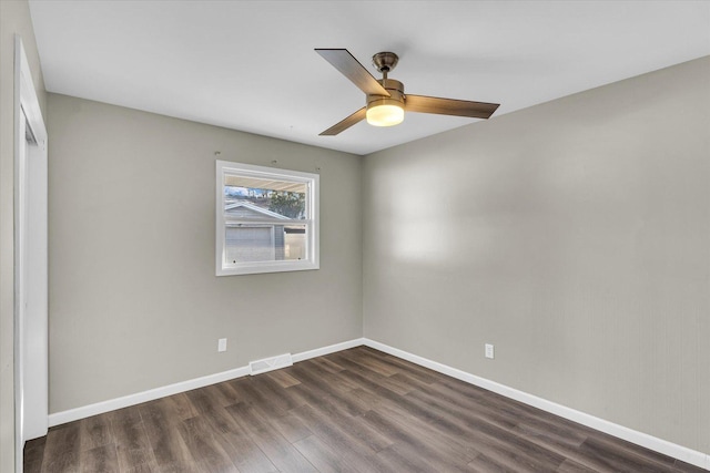 spare room featuring dark hardwood / wood-style floors and ceiling fan