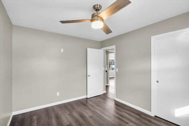 unfurnished bedroom featuring a closet, ceiling fan, and dark hardwood / wood-style flooring