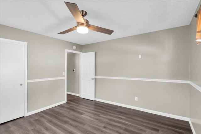 unfurnished room with dark hardwood / wood-style floors, ceiling fan, and a textured ceiling