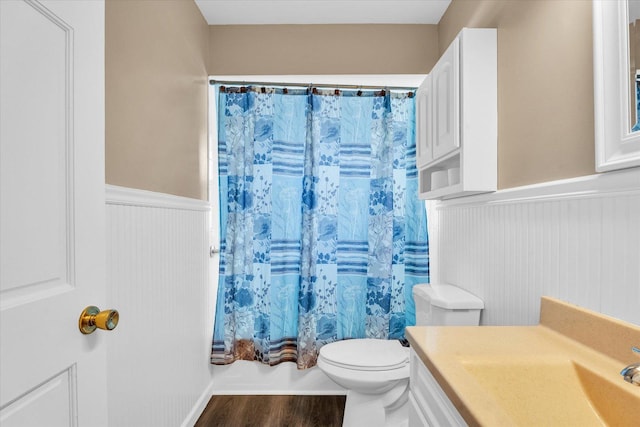 full bathroom featuring shower / bathtub combination with curtain, toilet, vanity, and hardwood / wood-style flooring