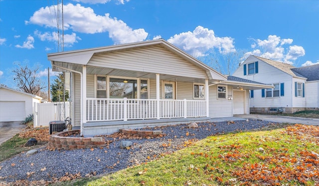 view of front of house featuring a garage, covered porch, and central air condition unit