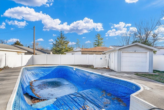 view of pool with a garage and an outdoor structure