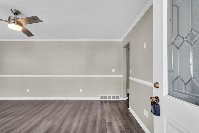 entryway with dark hardwood / wood-style floors, ceiling fan, and crown molding