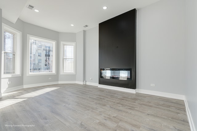 unfurnished living room featuring light hardwood / wood-style flooring