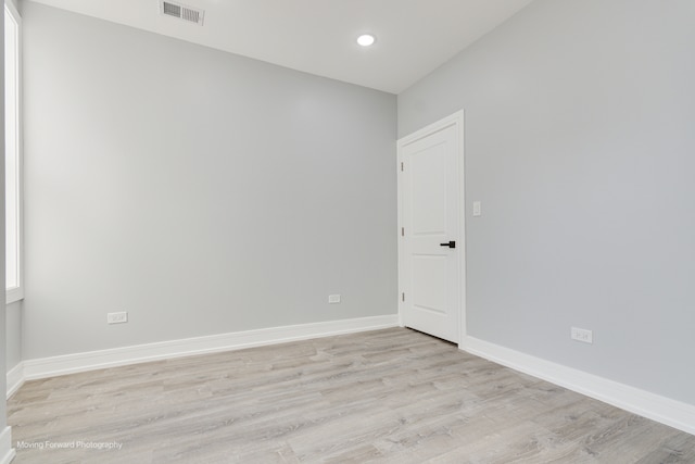 empty room with light hardwood / wood-style flooring