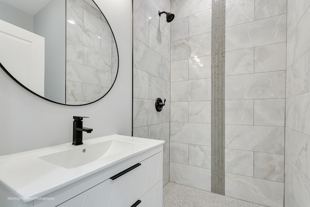 bathroom featuring vanity and tiled shower