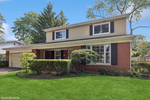 front facade featuring a front yard and a garage